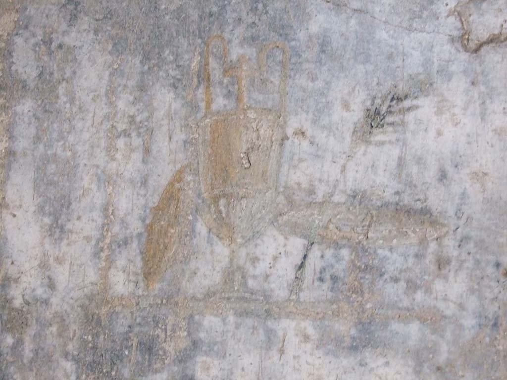 IX.7.20 Pompeii. December 2007. 
Room (i), west wall, black panel to south of central painting. Wall painting of trophy vase, small shield and palm.