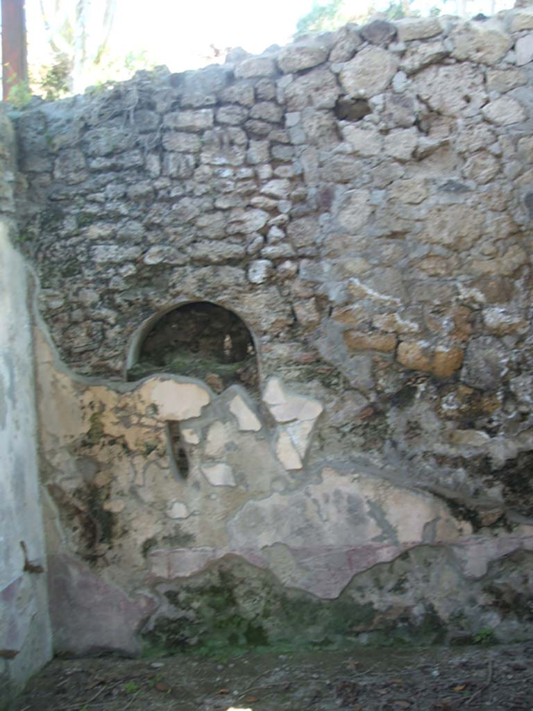 IX.7.20 Pompeii. May 2005. Niche in kitchen, room (p).
According to Boyce, in the west wall of the kitchen, in the south-west corner of the house, was once a niche.
This niche was coated with white stucco but was subsequently bricked-up.
See Boyce G. K., 1937. Corpus of the Lararia of Pompeii. Rome: MAAR 14. (p.88, no.440) 
See Giacobello, F., 2008. Larari Pompeiani: Iconografia e culto dei Lari in ambito domestico. Milano: LED Edizioni. (p.210, no.107)