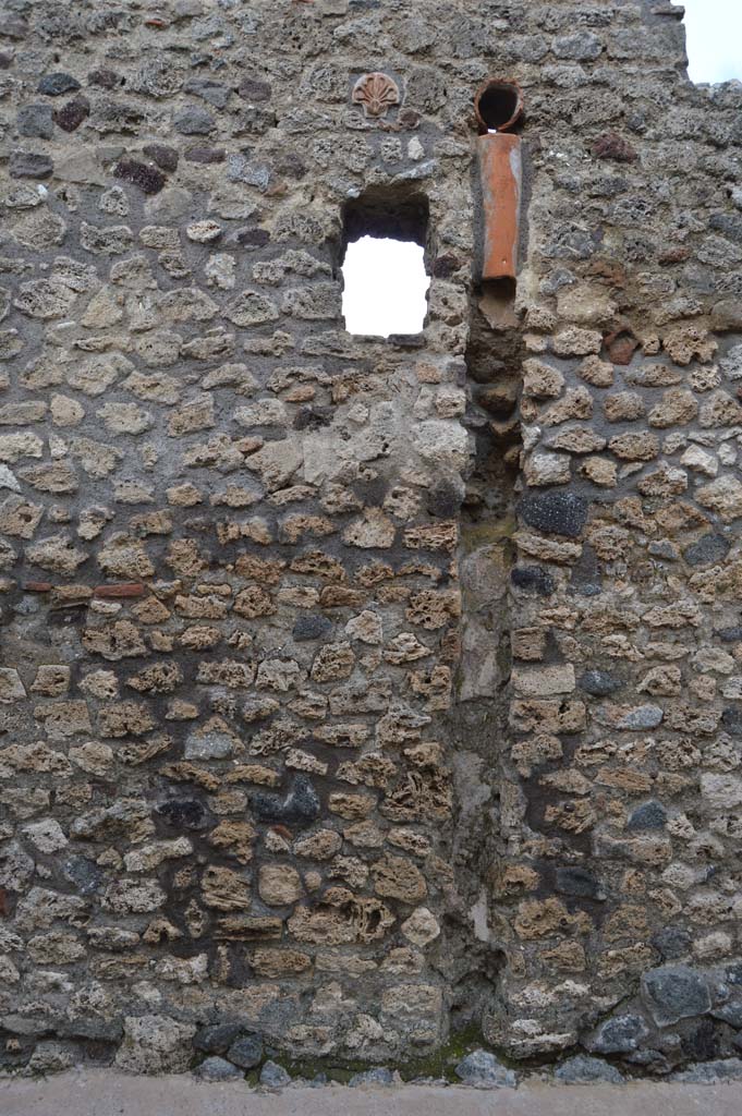 IX.7.21 Pompeii. March 2018. 
Looking east towards downpipe from upper floor, and terracotta decoration embedded in masonry.
Foto Taylor Lauritsen, ERC Grant 681269 DÉCOR.