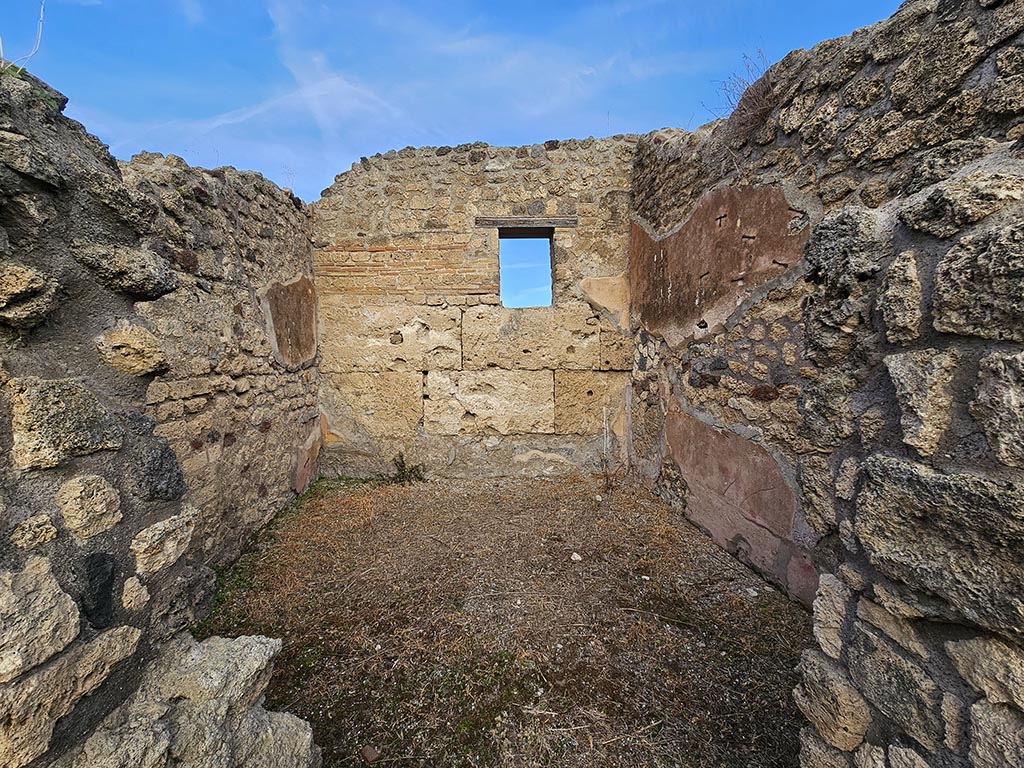 IX.7.21/22 Pompeii. November 2024. 
Looking north through doorway in north-east corner of atrium towards west, north and east walls. Photo courtesy of Annette Haug.