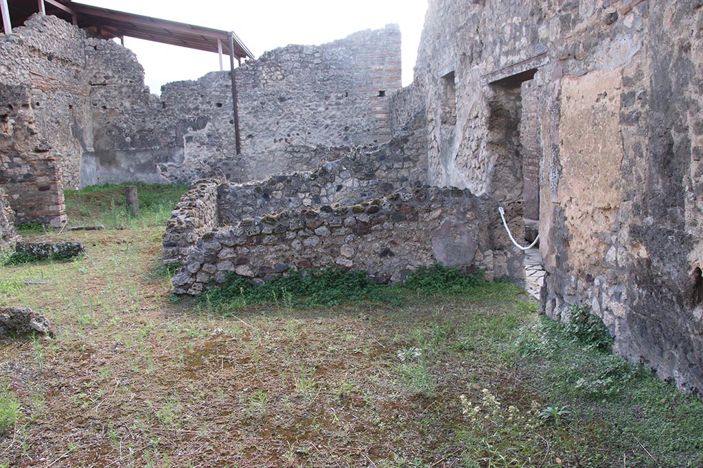 IX.7.21 Pompeii. October 2024. 
Looking south across west side of atrium, with entrance doorway, on right. Photo courtesy of Klaus Heese.