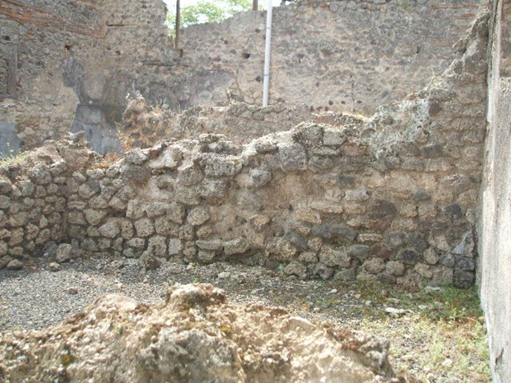 IX.7.21 Pompeii. May 2005. Looking south across rooms on right side of entrance.
According to Mau, the left end of this room would have been a small area accessible by two doorways and separated from the corridor by a thin wall. The right end of this room was probably used as a dining room. See Mau in BdI, 1882, (p.184)
According to Eschebach these would have been the kitchen, at the right end, and storage-room for amphora, on the left end. See Eschebach, L., 1993. Gebäudeverzeichnis und Stadtplan der antiken Stadt Pompeji. Köln: Böhlau. (p.435)