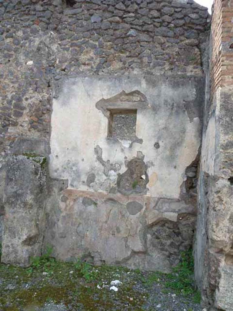 IX.8.2 Pompeii. May 2010. West wall of front room of shop, with window now to IX.8.1, in centre. According to Garcia y Garcia the painting of a sacred landscape, in the middle of the central panel on the west wall is still partially discernible. Perhaps this painting has been removed from the wall for safe-keeping and a window inserted. 
See Garcia y Garcia, L., 2005. Pupils, Teachers and Schools in Pompeii. Roma: Bardi editore. (p. 74-5, with figs 43-45 showing three versions of the sacred landscape, now in the German Archaeological Institute of Rome).See De Carolis, E. 1989. Italienische Reise. Naples: Bibliopolis, (p.250 & fig. 92 on page 323)