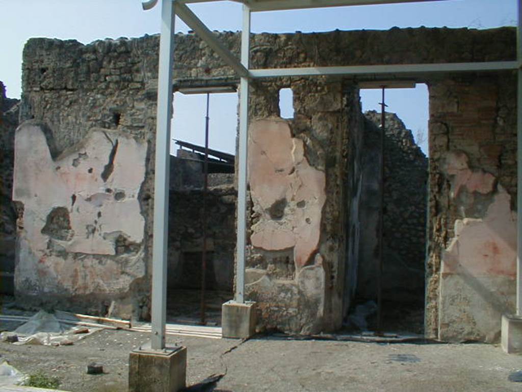 IX.8.6 Pompeii.  September 2004.  Doorways to Rooms 7 and 6 on west side of atrium.