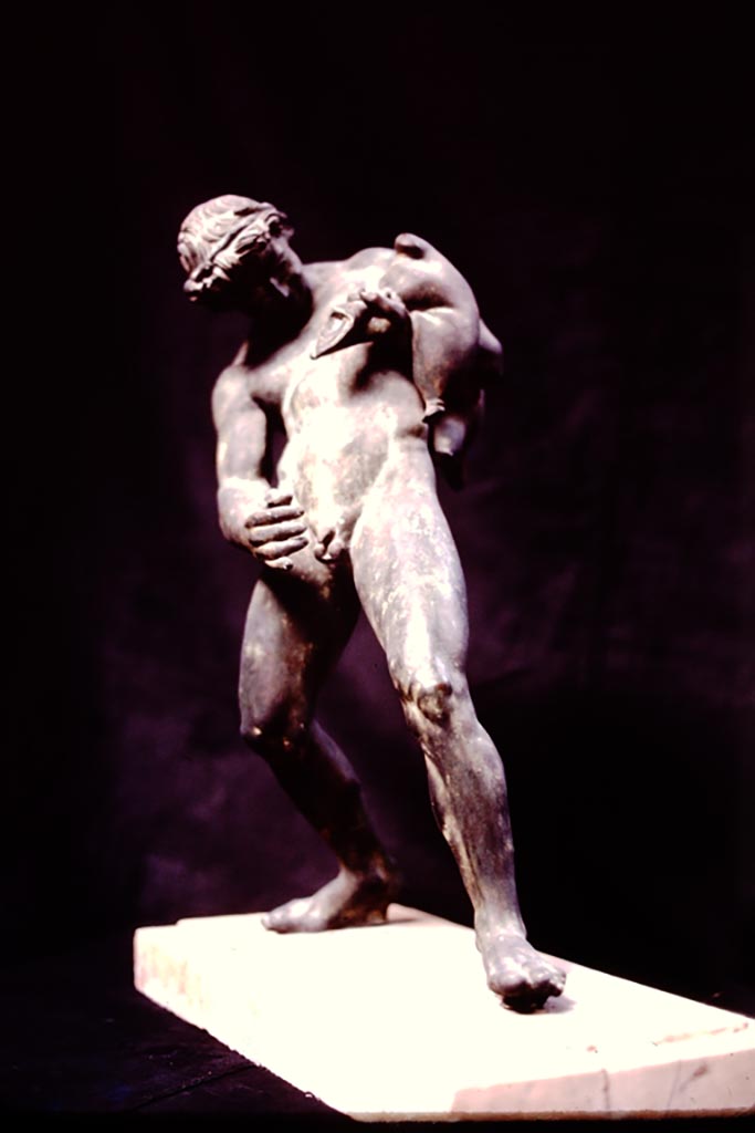 IX.8.6 Pompeii, 1982 or 1983. 
Bronze statue of satyr (0.51m high) found standing on a small tufa base in the middle of the rounded part of the north edge of the pool, facing south.
Now in Naples Archaeological Museum. Inventory number 111495. (Ruesch no. 815).
Source: The Wilhelmina and Stanley A. Jashemski archive in the University of Maryland Library, Special Collections (See collection page) and made available under the Creative Commons Attribution-Non-Commercial License v.4. See Licence and use details.
J80f0510