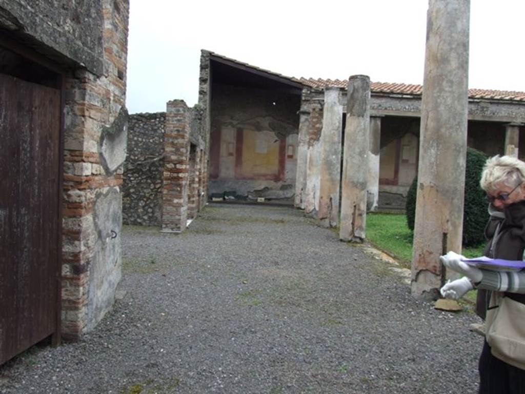 IX.8.6 Pompeii. March 2009.  South Portico area.  Looking west from outside Room 12.  Cuts in the sides of the lower columns indicate where there had been a wooden fence.  See Jashemski, W. F., 1993. The Gardens of Pompeii, Volume II: Appendices. New York: Caratzas. (p244)