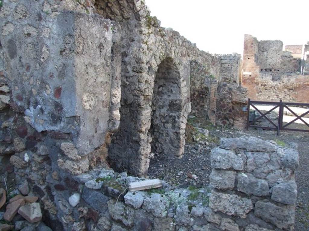 IX.9.2 Pompeii. March 2009.  Looking north from cubiculum “d” through window into atrium with stairs to upper floor, and 3 arched recesses underneath.