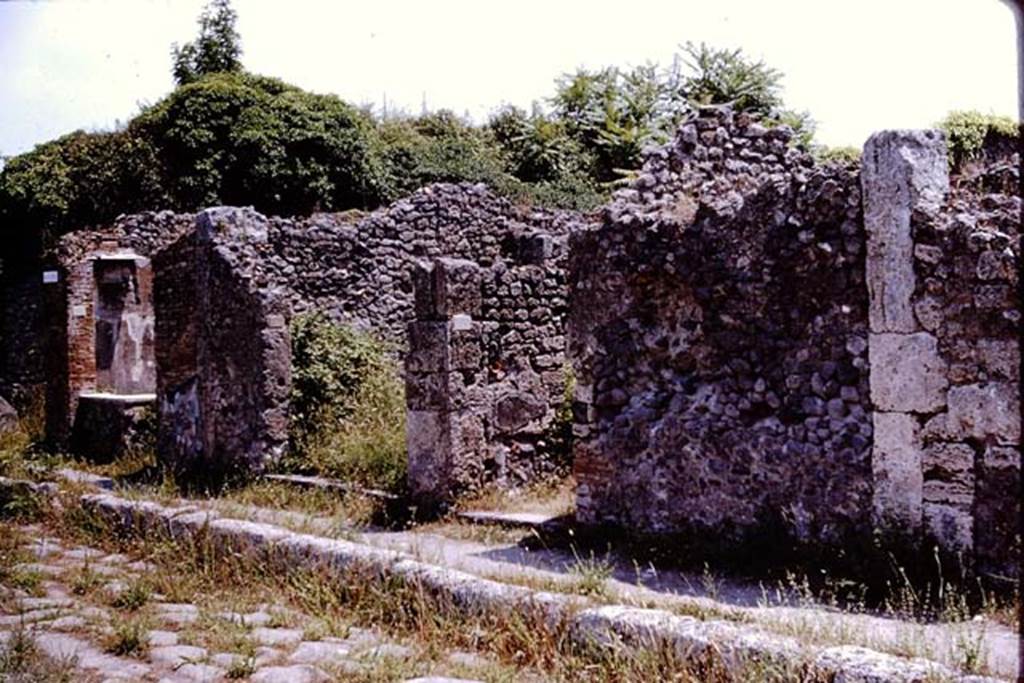IX.9.6, Pompeii. 1964. Looking towards doorways on east side of insula 9, on south side of  Via di Nola.   Photo by Stanley A. Jashemski.
Source: The Wilhelmina and Stanley A. Jashemski archive in the University of Maryland Library, Special Collections (See collection page) and made available under the Creative Commons Attribution-Non Commercial License v.4. See Licence and use details.
J64f2036