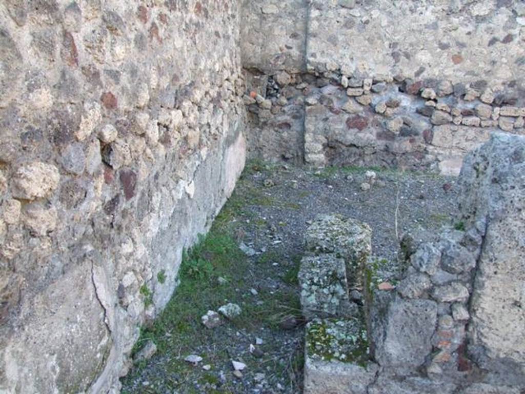 IX.9.a Pompeii. March 2009. Looking north into room “g”, on north-west side of the garden.
The room was described as opening from the north portico with two doorways of varying widths. The room was quite spacious and used maybe as a triclinium. It had flooring of crushed brick. The walls were painted yellow with stucco relief and green painted cornice, divided by narrow bands of white stucco on a red painted background and ornamented with leaves. Between the panels and the plinth (zoccolo) ran a band of stucco also in relief, imitating coloured marble.  Later this decoration was altered, as could be seen on the plinth of the west wall. See Notizie degli Scavi, 1888, p.515