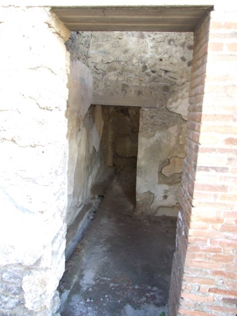 IX.9.c Pompeii. March 2009.  Anteroom with drain on south side which emptied into the street. According to NdS, this room had flooring of signinum, and walls painted with a yellow background, although the frieze was painted to look like imitation marble. In this room two bronze seals were found –
on 12th April 1887, with the wording - Q. Nolani \ Primi (see Notizie degli Scavi, 1887. p. 245), and
on 21st June 1887, with the wording - C. Salpici \ Rufi (see Notizie degli Scavi, 1887, cit. p. 379).
See Notizie degli Scavi, 1889, p.129