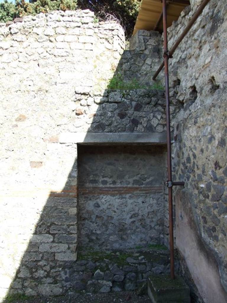 IX.9.c Pompeii. March 2009. East wall of south-east corner of portico area.  According to NdS, embedded in the east wall of the peristyle was a rectangular recess, about 0.50m deep. Found on its podium were several tiles stacked in a certain order. Another recess, smaller and not so deep, was found embedded nearby in the south wall.  Above, in this south-east corner of the peristyle, a mezzanine floor was found.
See Notizie degli Scavi, 1889, p.129