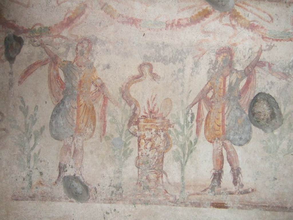 IX.9.c Pompeii. December 2005.  Kitchen.  Lararium painting.   
Two Lares either side of a round altar which has a snake winding round it.