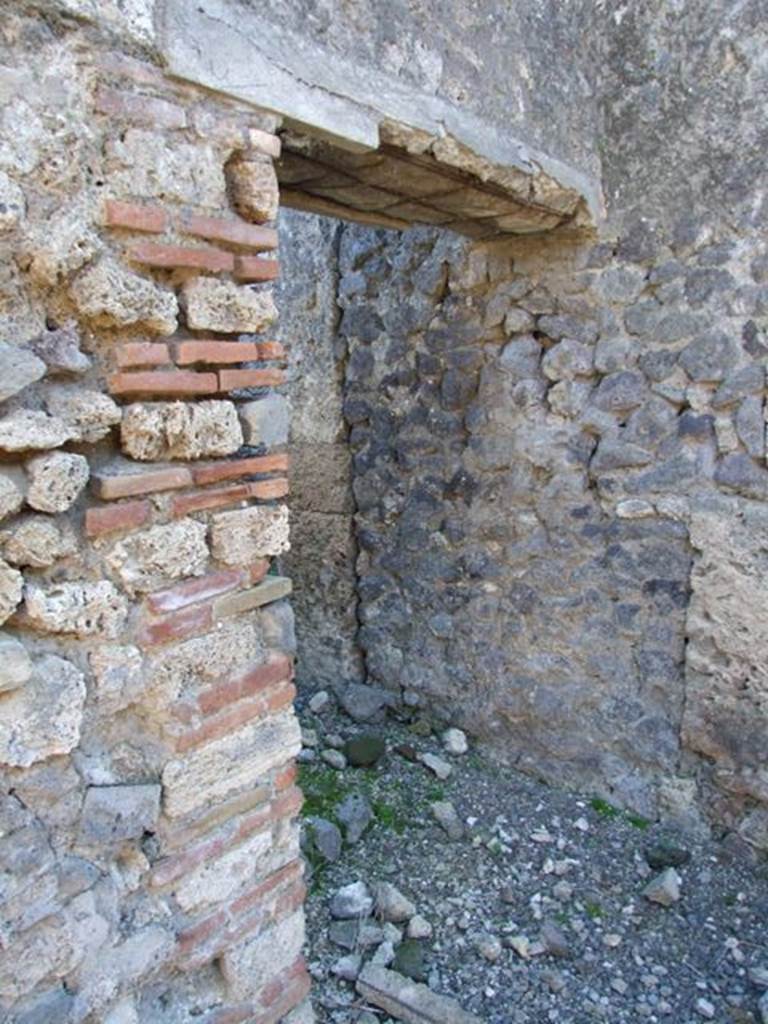 IX.9.d Pompeii. March 2009. Doorway to rooms h and i.  
Room with stairs to upper floor, and latrine underneath.
On the left of the doorway, on the wall of the atrium, a graffito was found. It read – 
CTXXXV
PLXXXVII