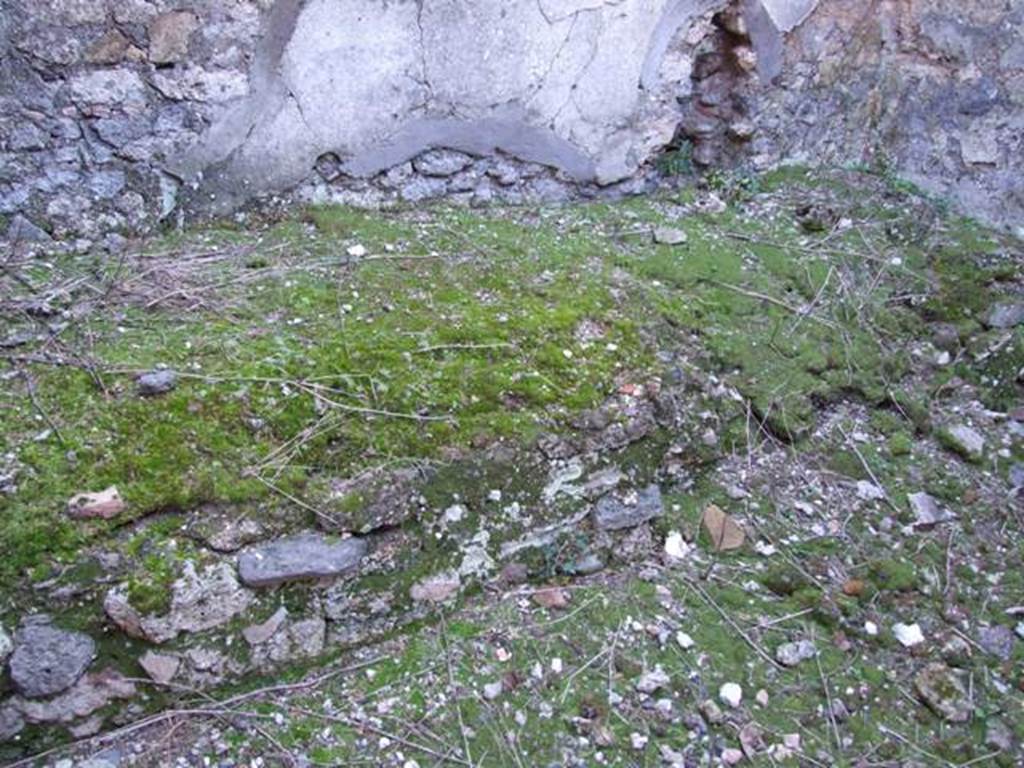 IX.9.d Pompeii. March 2009. Room k, south wall of kitchen with hearth or bench.
According to NdS, a large masonry base was found in the kitchen, whose diameter was greater than 1.20m Evidently, this large hearth was also used for some other thing, perhaps they used iron tripods on the base, because on this base there was no trace of fire.
See Notizie degli Scavi, 1889, p.130-1.