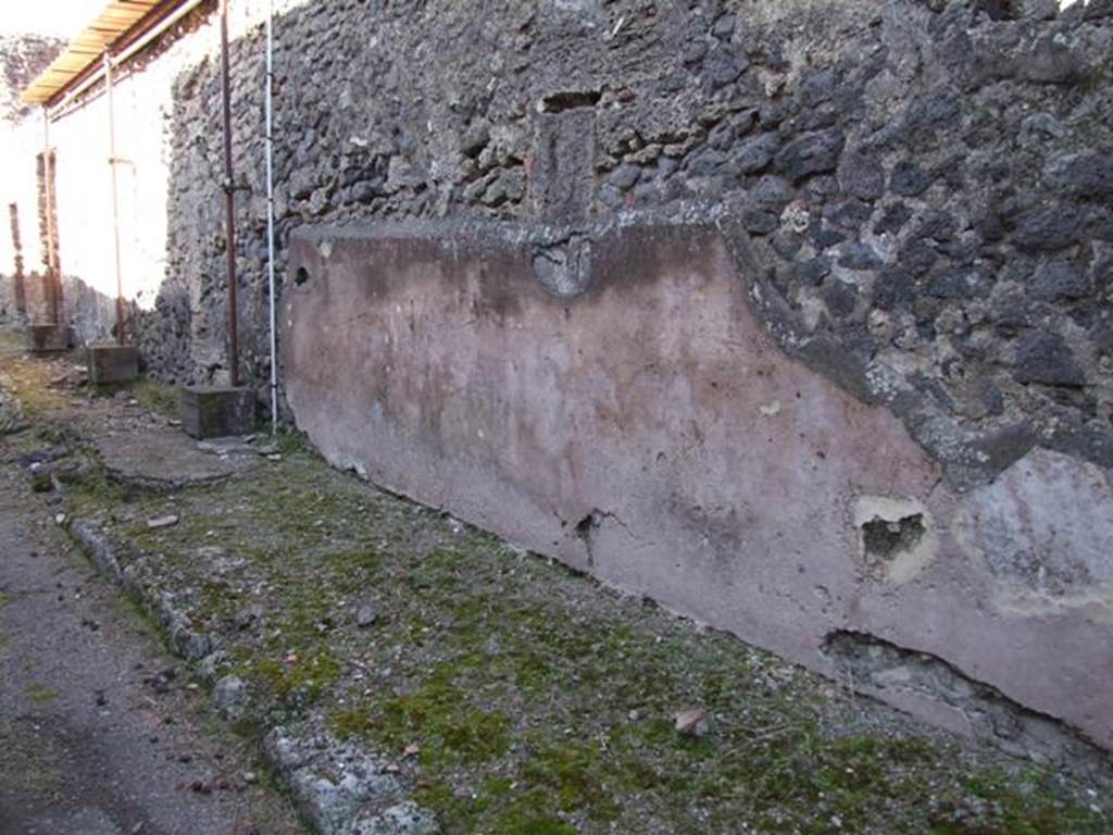 IX.9.d Pompeii. March 2009. Looking north along east side of vicolo.Exterior plastered and painted street wall between IX.9.c and IX.9.d.