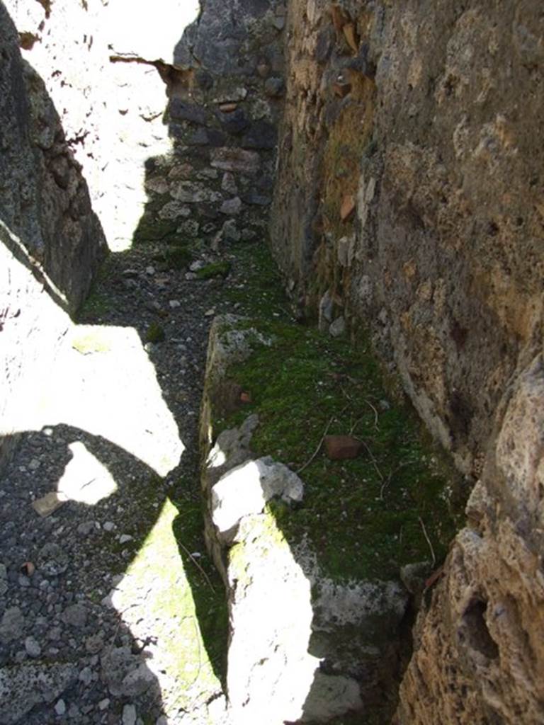 IX.9.f Pompeii. March 2009. Small room with staircase. The base of stairs was against the south wall. The latrine was at the far end, under stairs.