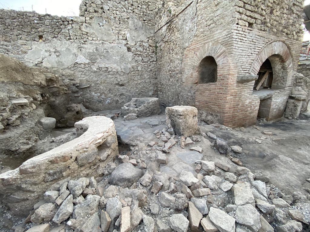IX.10.1 Pompeii. December 2023. Bakery room 7.
The bakery is ascribed to a building phase, which we are led to place in the post-seismic period of 62 AD on the basis of the wall evidence. 
When creating the production plant, care was taken to supply drinking water via a pipe that originates from the nearby water tower located at the north-east corner of IX.10, reaches the house at number 2 where the laundry is located, runs diagonally across the house at number 1 and finally flows into a rectangular basin in room (7).
Photograph © Parco Archeologico di Pompei.
See Pompeii E-Journal 08, 08.12.2023, p. 87, figg. 2 and 3. Download: PAP e-journals 2023 collection volumes 01-09