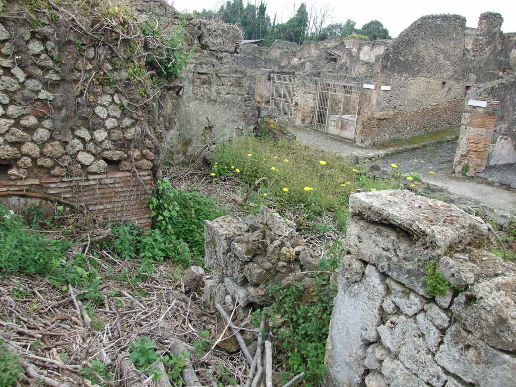 IX.10.1 Pompeii. May 2010. Bakery room 7, looking north-west from near the oven 7a. 
Looking towards the Via di Nola across the remains of bread making room 4 on the west side of the entrance.