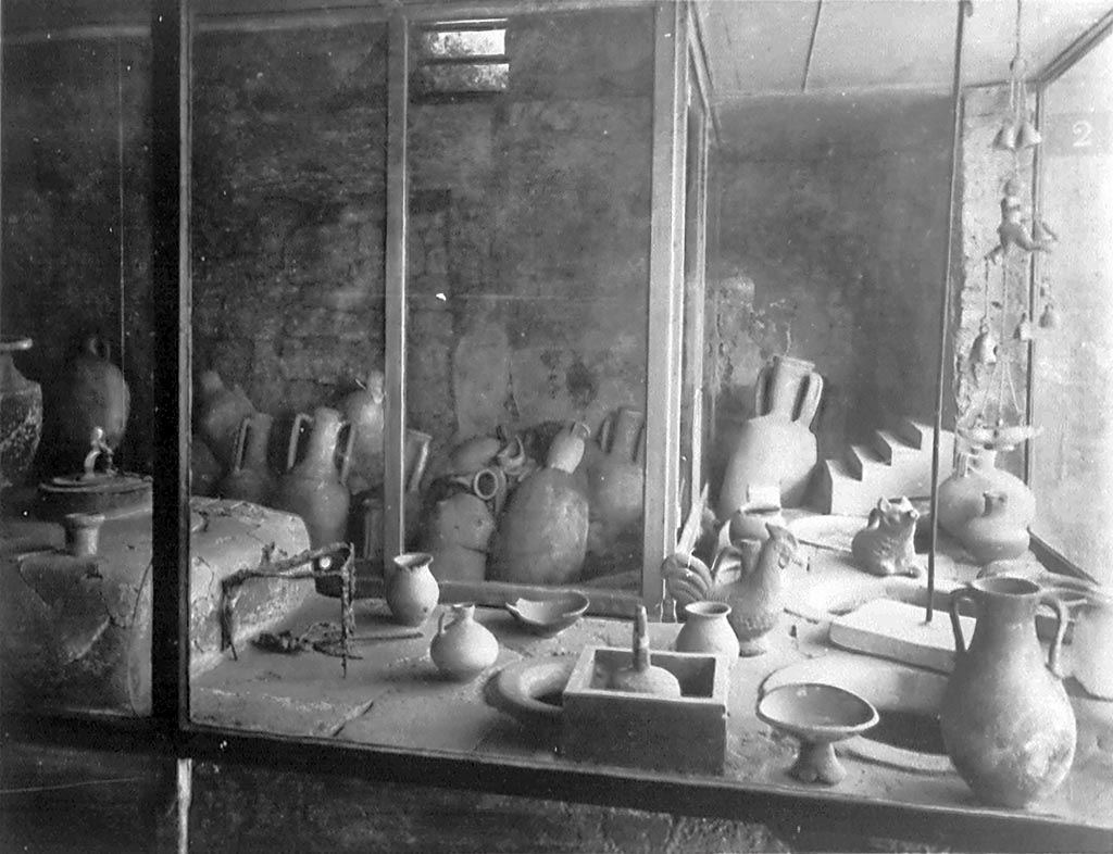 IX.11.2 Pompeii. Old postcard, about 1935, showing counter with a number of items displayed on it.