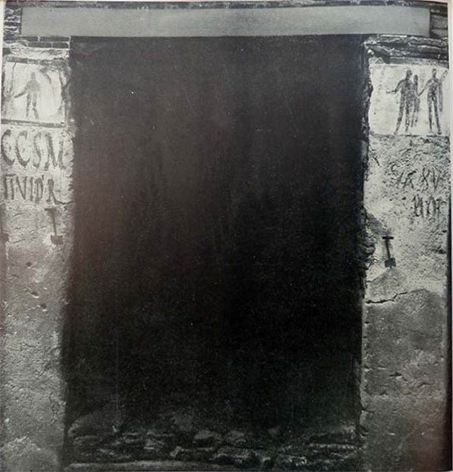 IX.11.7 Pompeii. Old excavation photo from 1912 or 1915. Entrance doorway with paintings and graffiti.
According to Boyce, (note, he allocated the number as being IX.IX.7) –
On each pilaster was a painting subsequently covered over by a new layer of whitewash (dealbatio) upon which a new painting was then done.
Of these four paintings three are known to us –
On the left pilaster, the earlier painting represented a poorly preserved male figure probably Hercules.
On the right pilaster, the earlier painting was of Minerva pouring a libation upon a burning altar (ara pulvinata); the later painting was of Hercules leading a pig adorned with a red band.
See Boyce G. K., 1937. Corpus of the Lararia of Pompeii. Rome: MAAR 14. (p.112, no.26).
According to Fröhlich,
Both pictures are on a white background and dark framed.
The left picture was covered by a younger, thin plaster, which fell off in the course of the excavation. Shown is a man seen from the front, naked except for a garment hanging from the left side of the body, which lowers the right arm in sacrifice and strains its right leg, perhaps Hercules.
In the right picture, gradually due to the progressive weathering, three successive phases came to light, whereby for some time the youngest and the middle phase, later the middle and the oldest, were to be seen together.
1. Youngest phase: 
Hercules, naked except for the lion's skin over the left forearm, stands on his left leg, lowers his right arm in sacrificial position, carries the club in his left arm and with his left hand leads a small pig, in profile, with sacrificial bandage.
2. Middle phase: 
Hercules, naked except for the lion's skin over the left shoulder, stands on his right side, lowers his right hand in sacrificial posture and holds in his left arm the club leaning against his shoulder.
3. Older phase: 
Minerva in green and white chiton and outer coat, yellow-green on the outside and red on the inside, a golden helmet on her head, a gold shield on the right, her right leg on a brown plinth, leans her left hand on the lance and sacrifices from the lowered right over a brown round altar.
Whether the pictures refer to the narrow house entrance no. 7 or belong to the shop No. 5/6, and / or to the shop No. 8, must remain open.
Dating: The Minerva of the oldest phase is of Third Style. The other phases cannot be dated any further.
See Fröhlich, T., 1991. Lararien und Fassadenbilder in den Vesuvstädten. Mainz: von Zabern. (p.337, F68)
See Notizie degli Scavi, February 1912 (p.62-64) and Notizie degli Scavi, 11th February 1915, (p.284-285)
