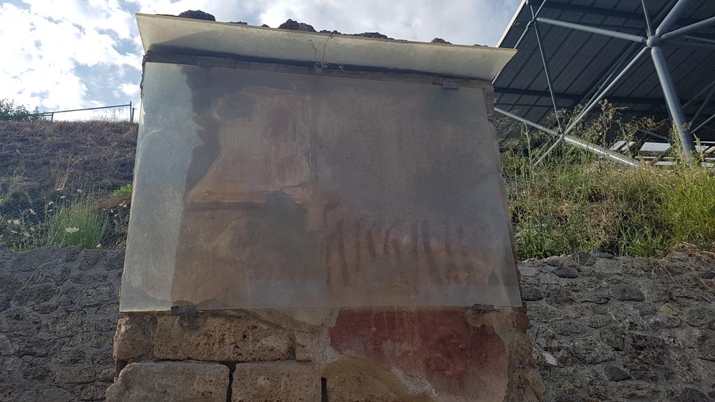 IX.11.7 Pompeii. August 2023. 
Pilaster on east side (right) of doorway, with remaining painting of Hercules and graffiti between doorways to IX.11.7 and IX.11.8. 
Photo courtesy of Maribel Velasco.