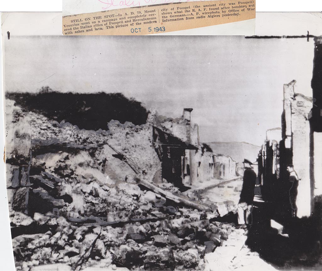 IX.12.1 Pompeii. October 1943. Looking east between IX.12 and I.8 on Via dell’Abbondanza.
Picture that according to the newspaper report “shows what the RAF found after bombing.....”.
The destroyed Houses of the Cenacoli Colonnati, following the aerial bombardment of 1943. Photo courtesy of Drew Baker.
The left pilaster of the front façade of IX.12.1 can be seen on the left.