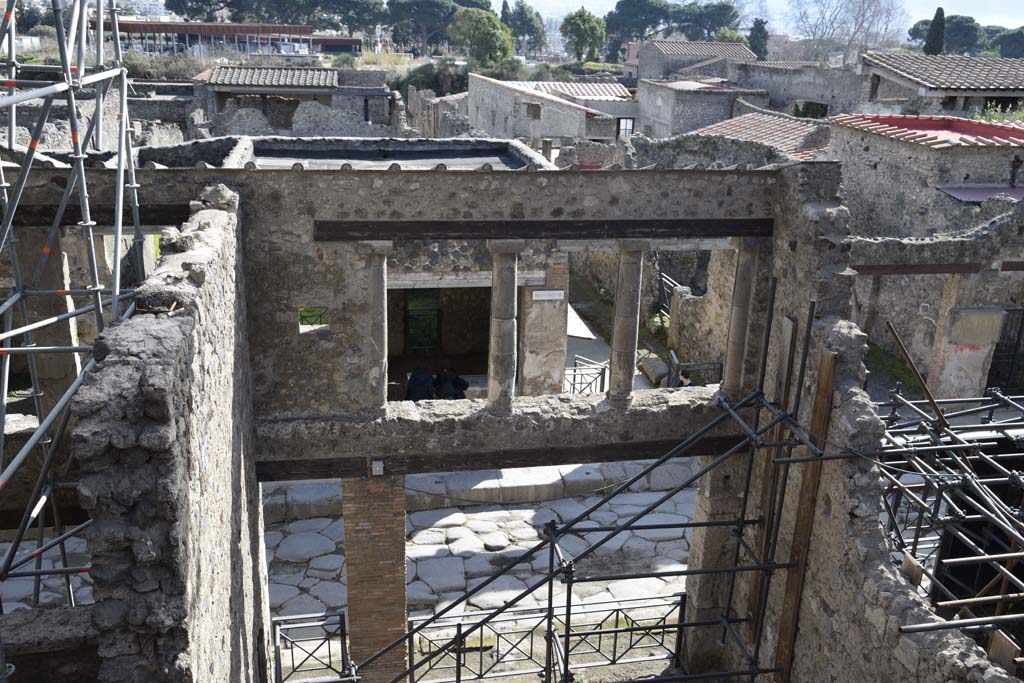 IX.12.2 Pompeii, on left, doorway to stairs to upper floor, with IX.12.1, entrance into room “a”, in centre. February 2017. 
Looking south across Via dell’Abbondanza. Photo courtesy of Johannes Eber.
