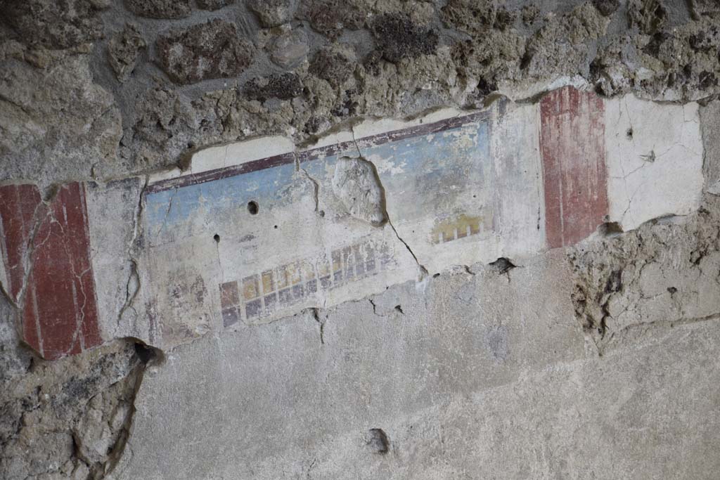 IX.12.4 Pompeii. February 2017. 
Room “f”, detail of painted east wall in room being excavated, on west side of bakery at IX.12.6. Photo courtesy of Johannes Eber.
According to Spinazzola, this painting showing a house with two-storey porticoes and windows, was the decoration of a zoccolo in a room on the upper floor.
See Spinazzola, V. Pompei, alla luce degli Scavi Nuovi di Via dell’Abbondanza (Anni 1910-1923), Vol.2, p.719, fig.690.