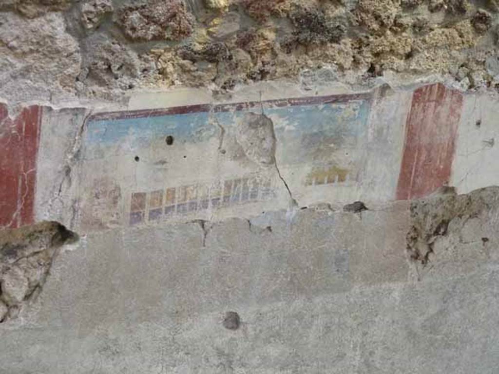 IX.12.4 Pompeii. May 2010. Room “f”, detail of painted east wall in room being excavated, on west side of bakery at IX.12.6.