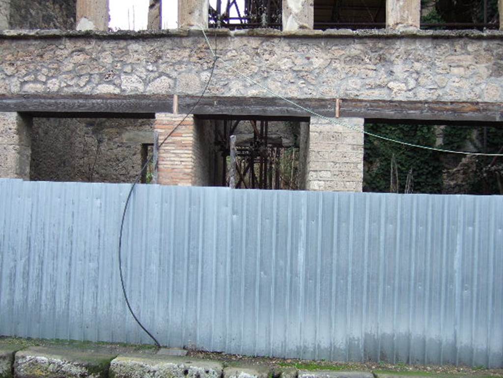 IX.12.4  Pompeii. December 2005. Entrance in centre. According to Garcia y Garcia, number 2 and 4 were hit by bombs in the air bombardment on 19th September 1943. See Garcia y Garcia, L., 2006. Danni di guerra a Pompei. Rome: L’Erma di Bretschneider. (p.158)