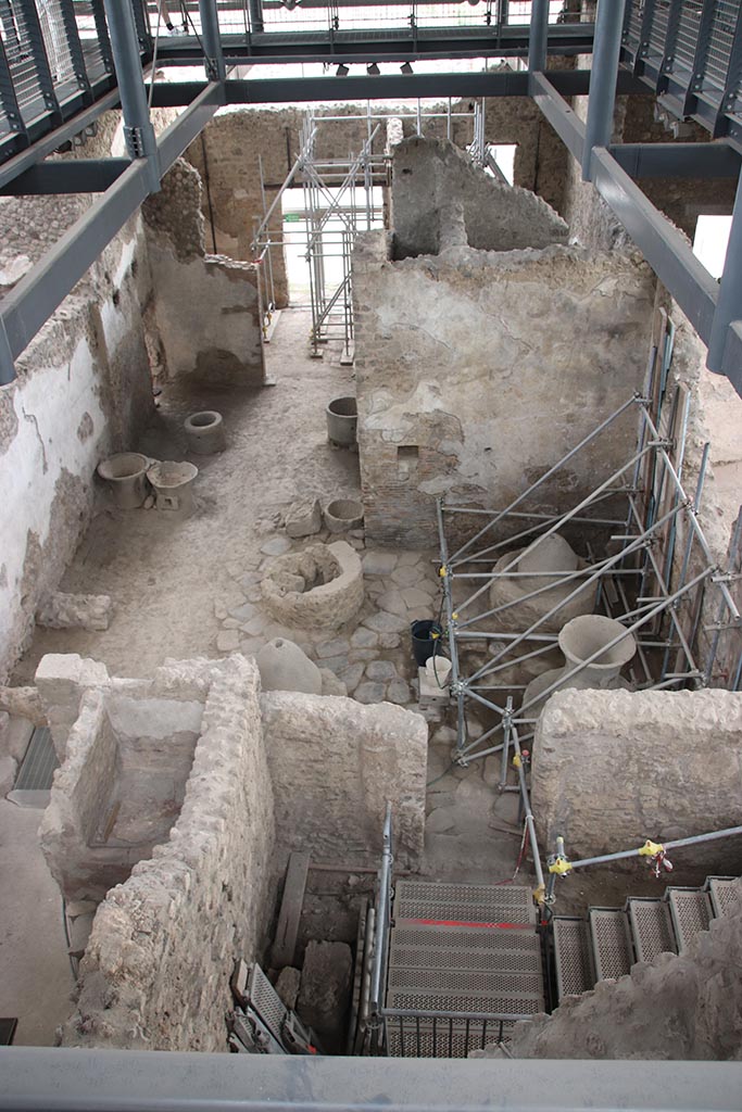 IX.12.6 Pompeii. October 2024. 
Looking south across the bakery room “e” and “f”, from room “g”. Photo courtesy of Klaus Heese.