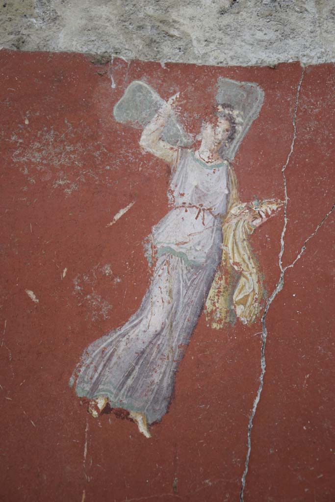 IX.12.6 Pompeii. February 2017. 
Room “m”, detail of flying figure from south side of central painting on west wall.
Photo courtesy of Johannes Eber.
