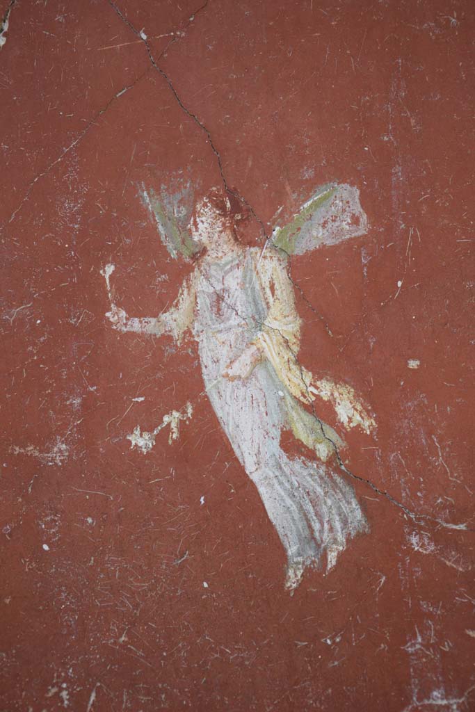 IX.12.6 Pompeii. February 2017. 
Room “m”, detail of painting of flying figure from north side of central painting on west wall.
Photo courtesy of Johannes Eber.