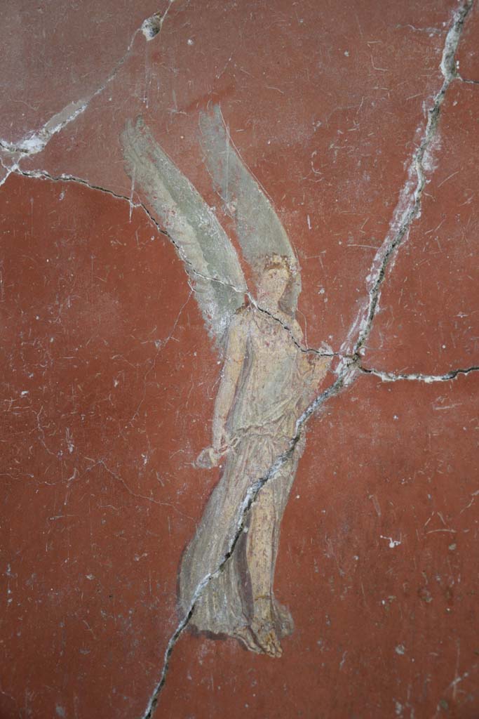 IX.12.6 Pompeii. February 2017. 
Room “m”, painting of flying figure on west side of central painting on north wall.
Photo courtesy of Johannes Eber.