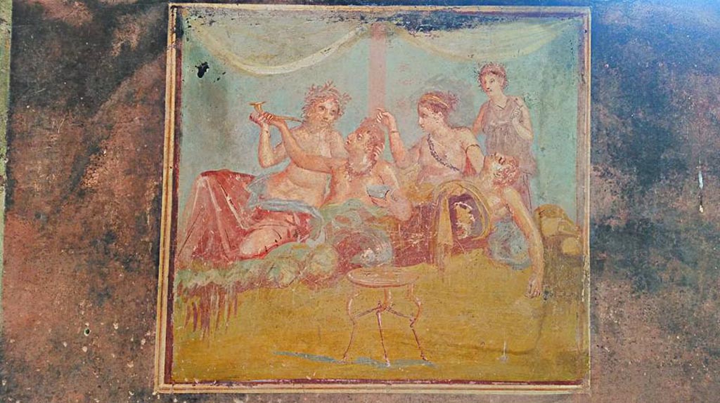 IX.12.6 Pompeii. 2016/2017. 
Room “m”, central painting from east wall of triclinium with banqueting scene. Photo courtesy of Giuseppe Ciaramella.