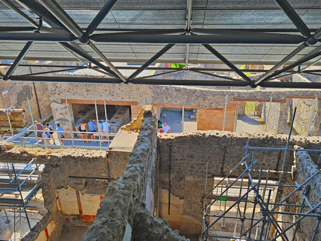 IX.12.7 on left, and IX.12.6 on right, Pompeii. June 2024. Looking south through entrance doorway towards Via dell’Abbondanza. 
Photo courtesy of Giuseppe Ciaramella.