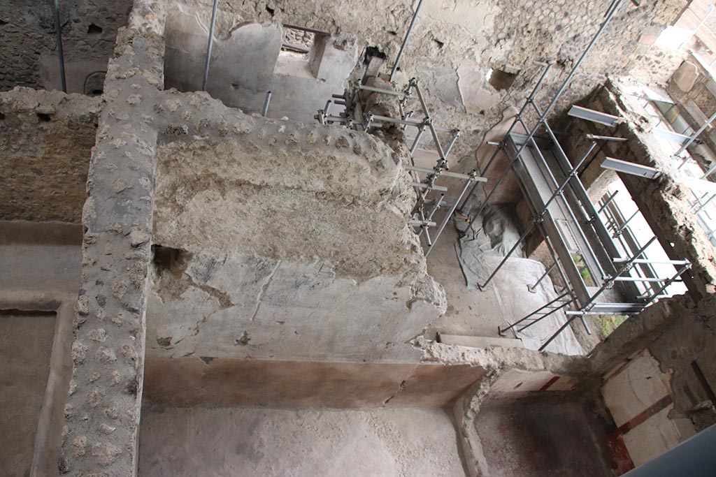 IX.12.6 Pompeii. October 2024. 
Looking east from above room “c2”, lower centre left, towards shop-room and rear room of IX.12.7. Photo courtesy of Klaus Heese.