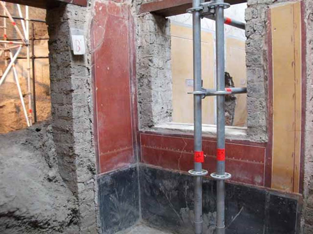 IX.12.9 Pompeii. May 2010. 
Room 11, west wall with doorway blocked by volcanic debris, north-west corner, and north wall with window into room 12.
