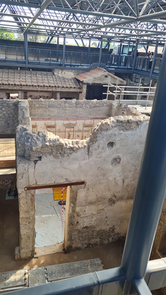 IX.12.A/IX.12.9 Pompeii. June 2024. Doorway into PAP room 18.
Looking east from room 2, atrium, towards peristyle 5, with monumental gateway, 7.   
Photo courtesy of Giuseppe Ciaramella.