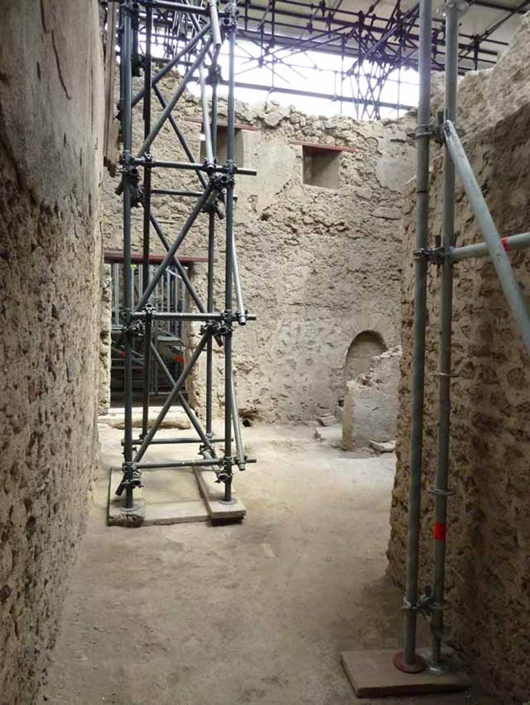 IX.12.9 Pompeii. May 2010. 
Room 1, kitchen and latrine. Looking east from east portico 5c, towards street entrance.
