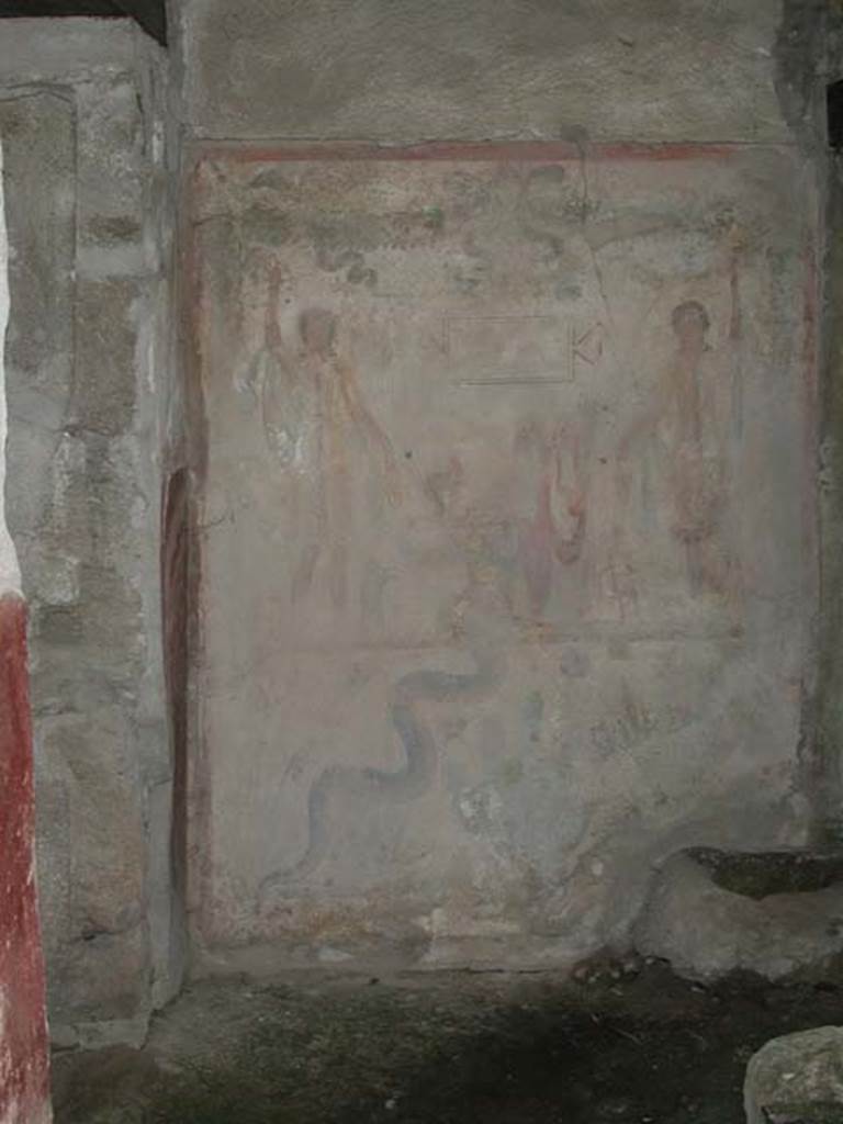 IX.13.1-3 Pompeii. September 2003. Room 21. Lararium by west wall of services atrium, near door to kitchen. Photo courtesy of Nicolas Monteix.