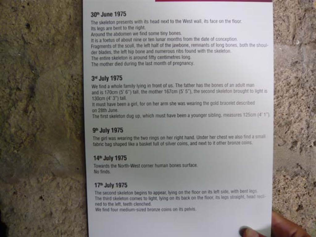 IX.13.1-3 Pompeii. May 2012.  Room 10, information card with regard to finding of the skeletons.  Photo courtesy of Buzz Ferebee.