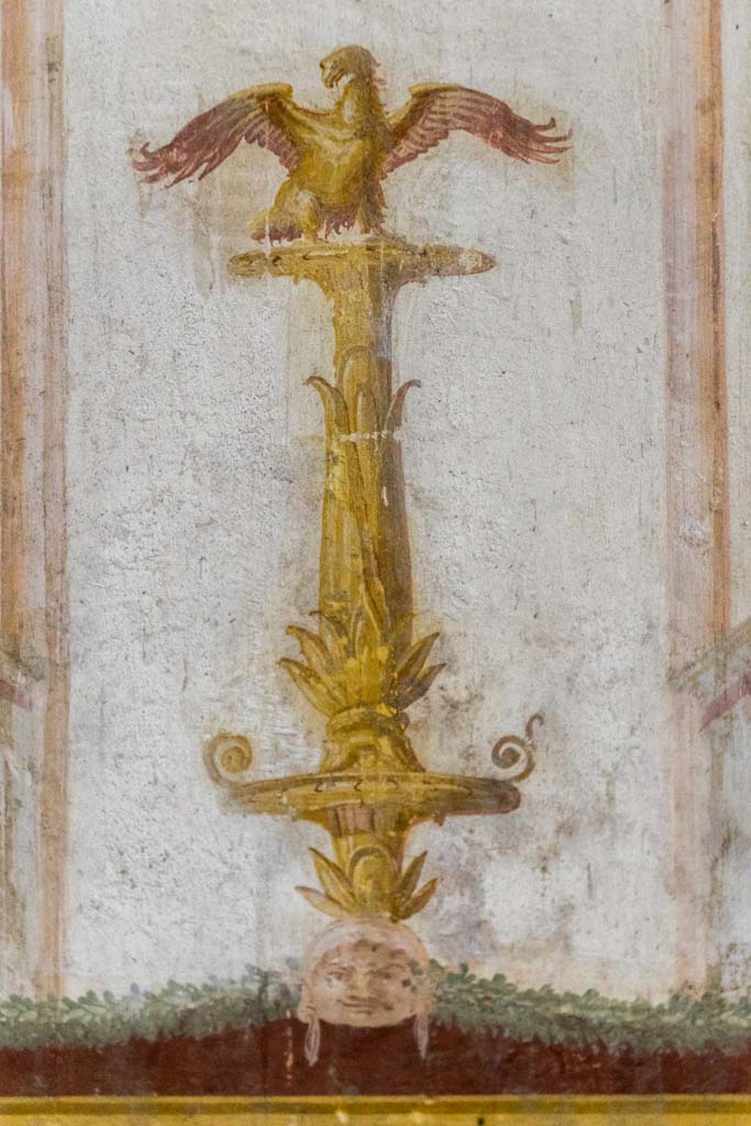 IX.13.1-3 Pompeii. October 2021. 
Room 11, detail from top of painted candelabra on west wall at south end. 
Photo courtesy of Johannes Eber.