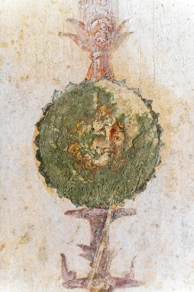 IX.13.1-3 Pompeii. October 2021. 
Room 11, detail of painted decoration/medallion from south side of central painting on east wall.
Photo courtesy of Johannes Eber.
