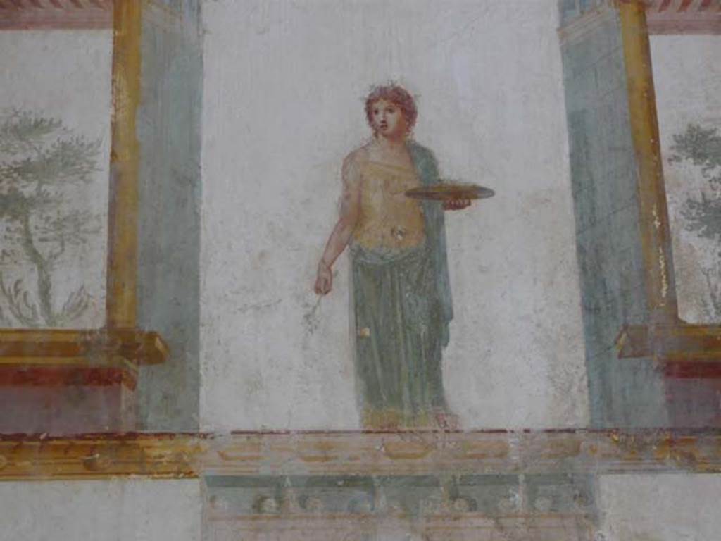 IX.13.1-3 Pompeii. May 2012. Room 11, detail of painted figure with plate, from south end of east wall. Photo courtesy of Buzz Ferebee.