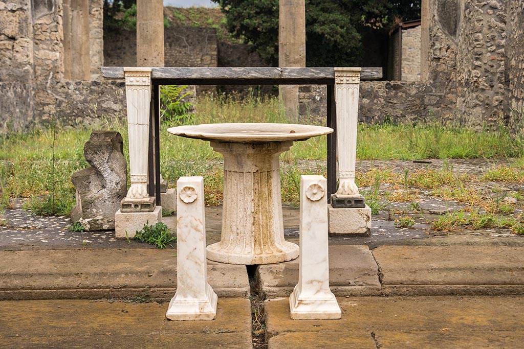 IX.14.4 Pompeii. July 2024. Items on south side of impluvium. Photo courtesy of Johannes Eber.
