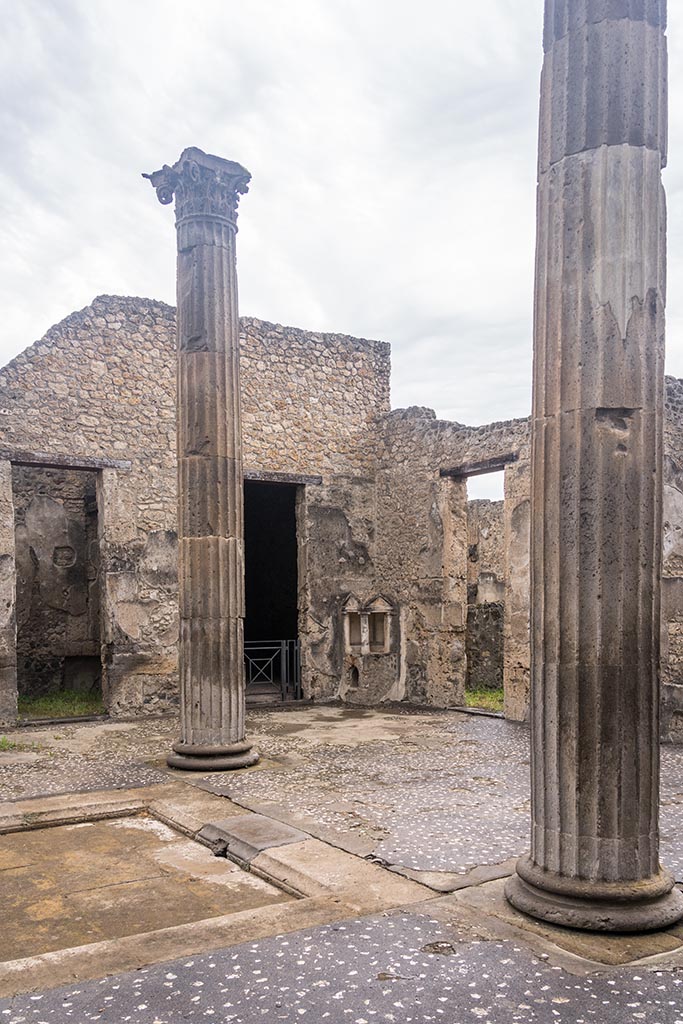IX.14.4 Pompeii. July 2024. 
Looking north-west across atrium towards Aedicula Lararium. Photo courtesy of Johannes Eber.