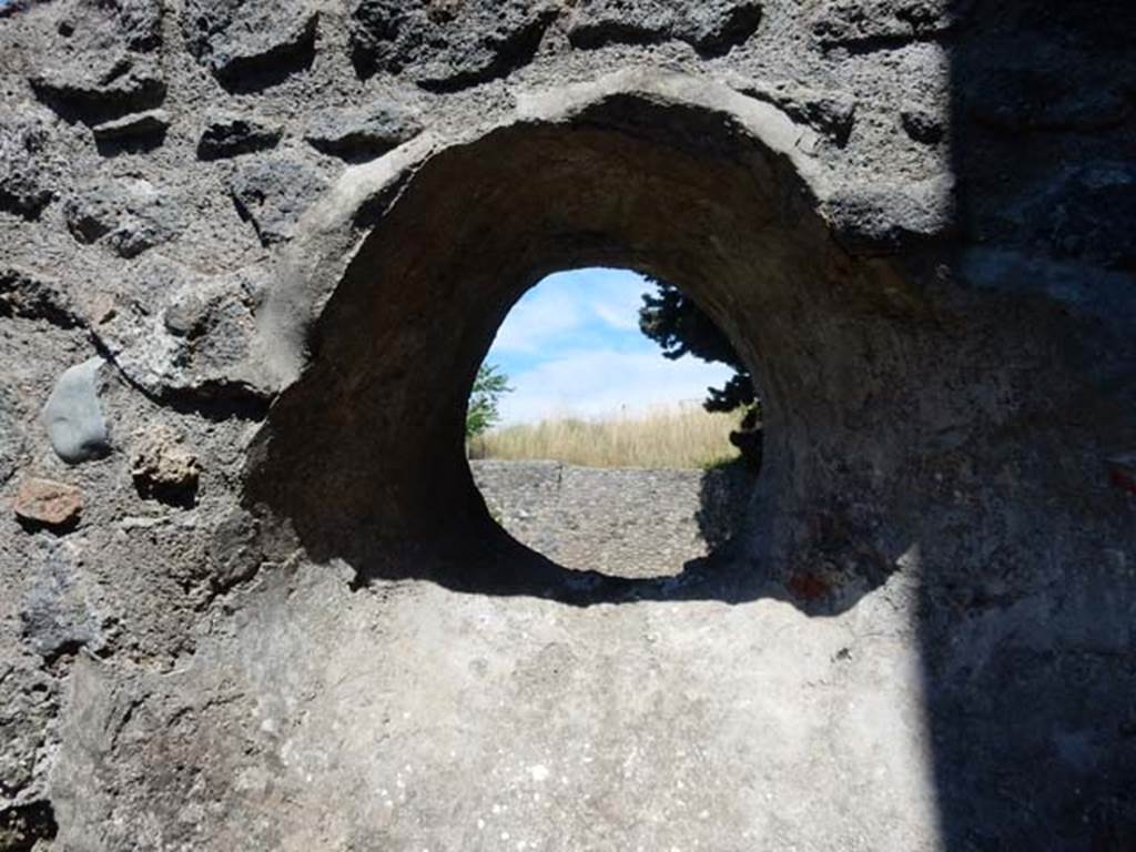 IX.14.4 Pompeii. May 2017. Looking east through circular window above latrine in room 8.  Photo courtesy of Buzz Ferebee.