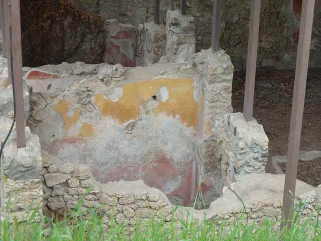 IX.14.c Pompeii. May 2010. Room 5, room on south side of entrance corridor. North wall. According to NdS, both rooms 4 and 5 had a similar wall decoration, low black plinth, red decorations and frieze of yellow. A square window was found high in the western wall. To the right of the south wall was a recess for the edge of a bed along the west wall. The flooring was of signinum with tesserae placed in lines forming a lozenge design. See Notizie degli Scavi di Antichità, 1911, p. 375.