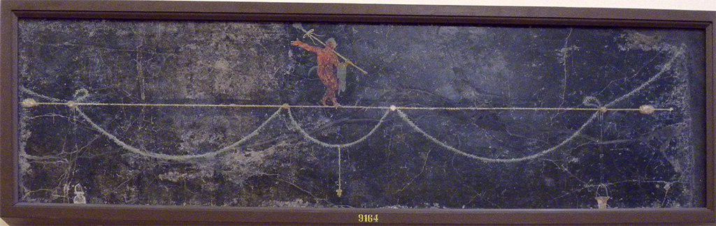 HGW06 Pompeii. Found in triclinium on 1st June 1748.  
Wall painting of a Satyr with a thyrsus on his shoulder and who is walking on a horizontal thyrsus.
Now in Naples Archaeological Museum. Inventory number 9164.